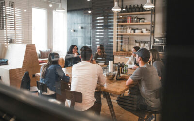 Seven individuals participate in a informal meeting