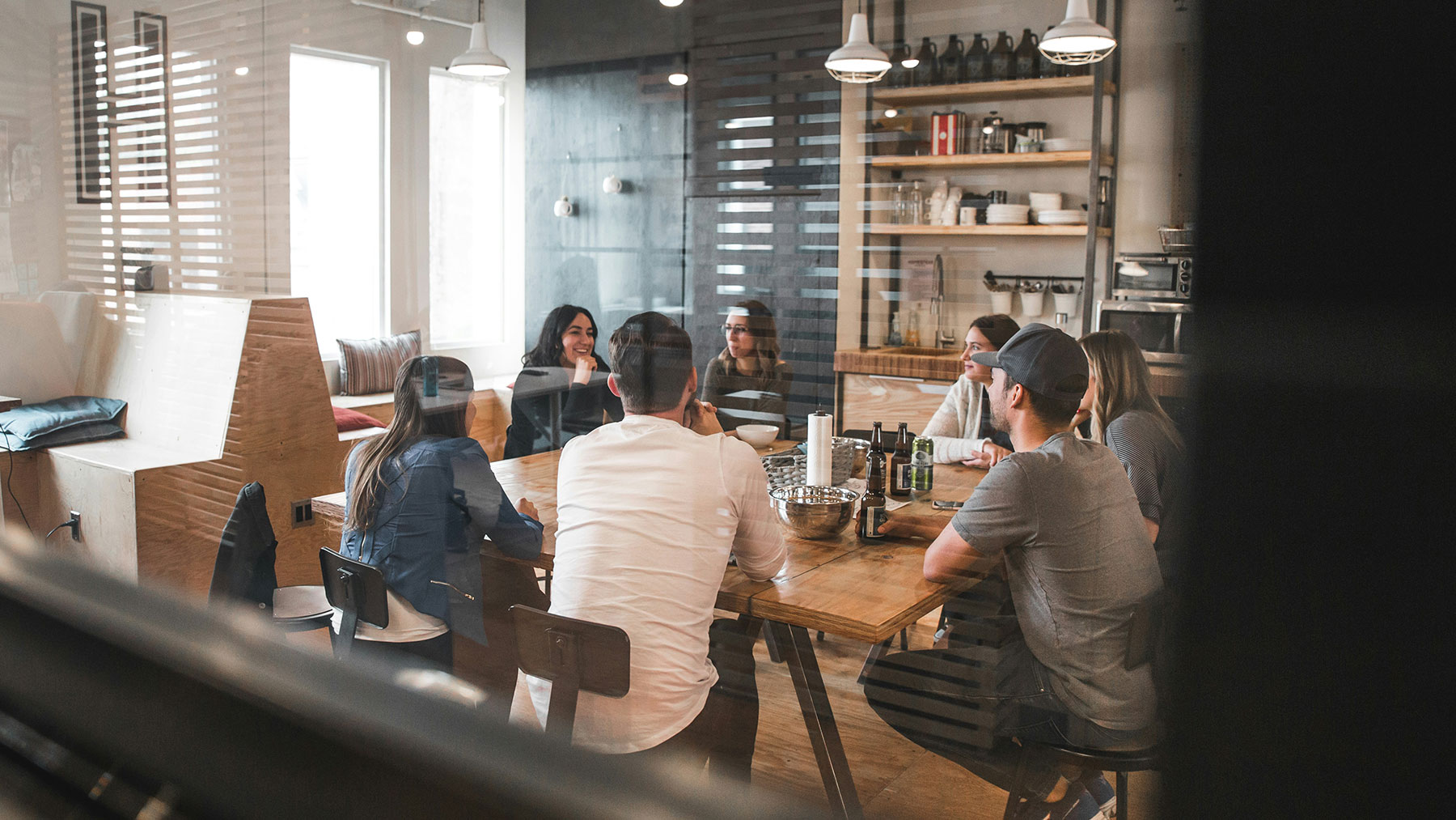 Seven individuals participate in a informal meeting