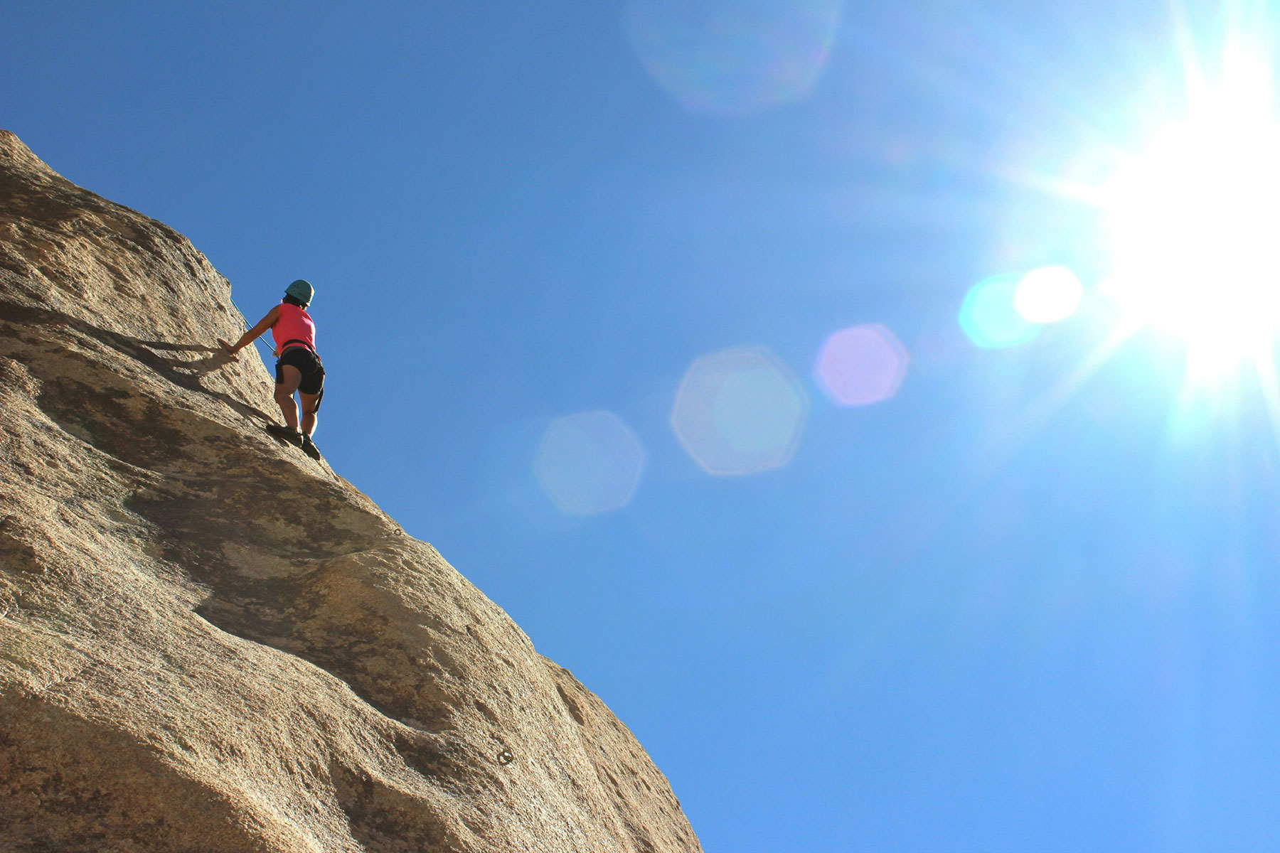 Climber about to reach a mountain top