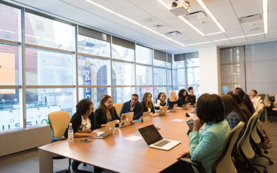 Multiple workers at a meeting in a conference room