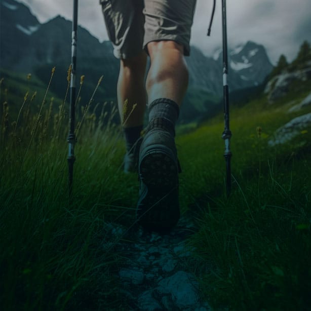 Hiker walks on a trail towards a mountain